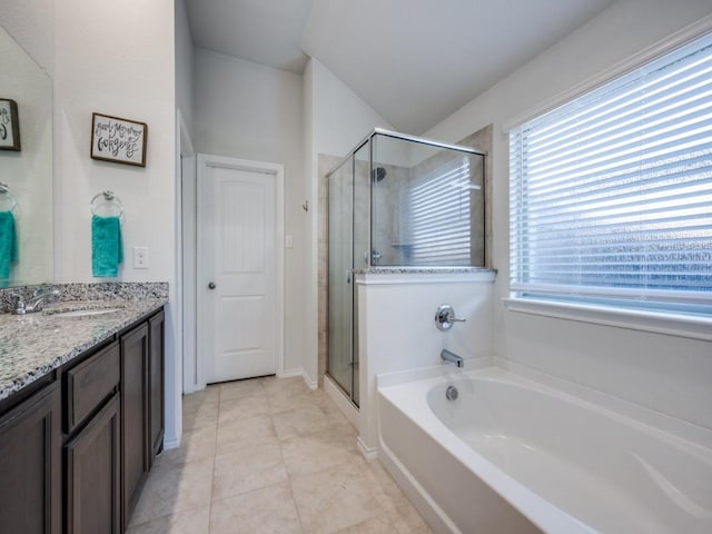 bathroom with shower with separate bathtub, vanity, and tile patterned floors