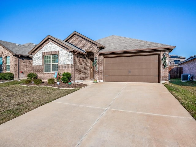 single story home with central air condition unit, a front yard, and a garage