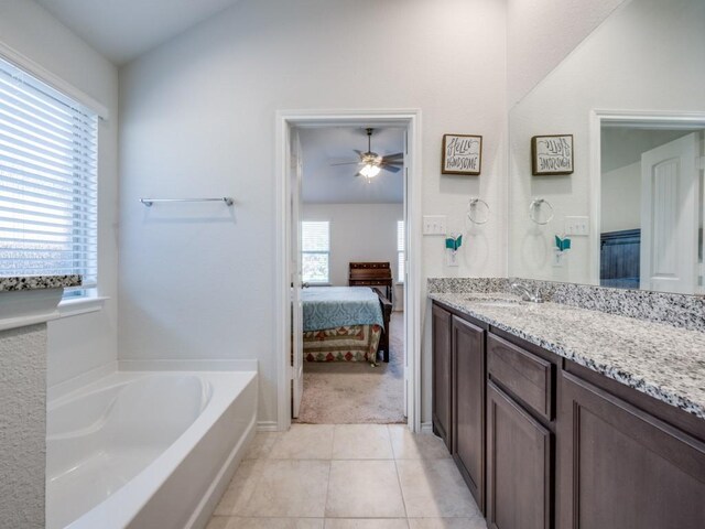 bathroom with tile patterned flooring, ceiling fan, a healthy amount of sunlight, and vanity