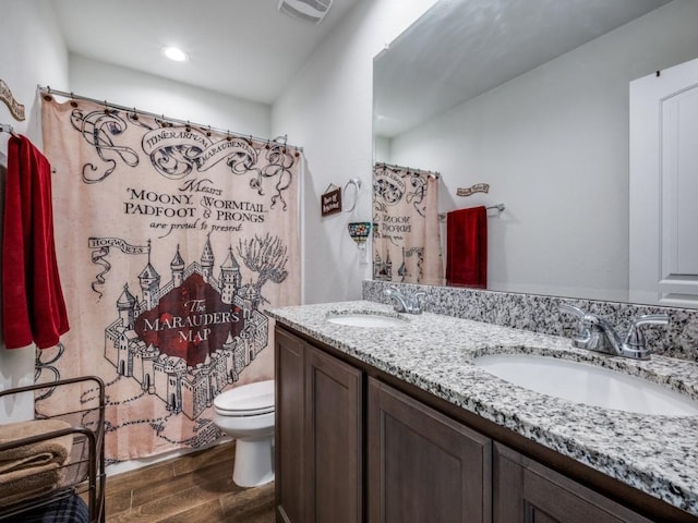 bathroom featuring a shower with curtain, wood-type flooring, toilet, and vanity