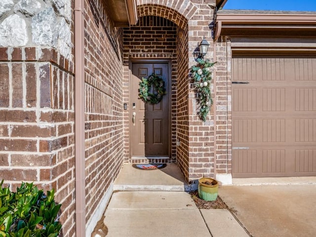 view of exterior entry with a garage