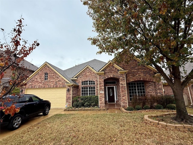 view of front of house featuring a garage and a front lawn