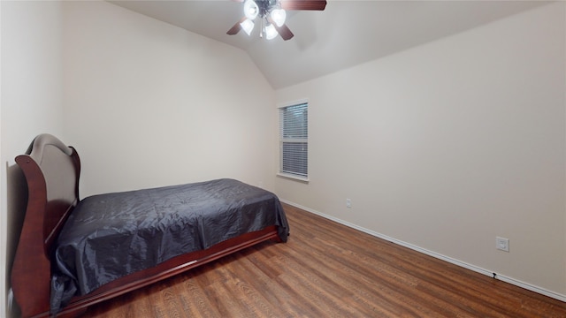 bedroom with ceiling fan, dark hardwood / wood-style floors, and lofted ceiling