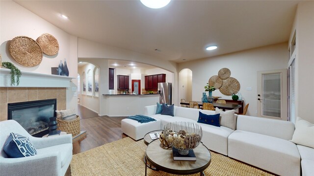 living room with hardwood / wood-style floors and a fireplace