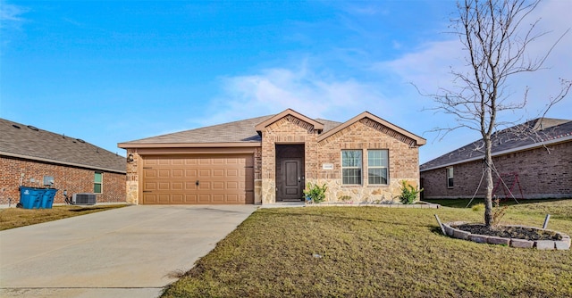 view of front of home with a garage, a front yard, and central air condition unit