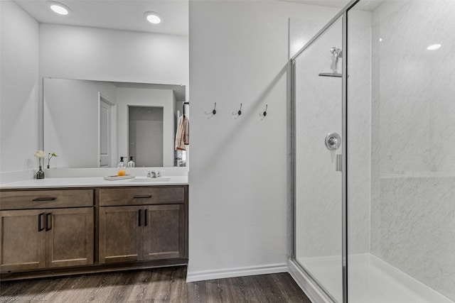 bathroom featuring vanity, an enclosed shower, and hardwood / wood-style floors