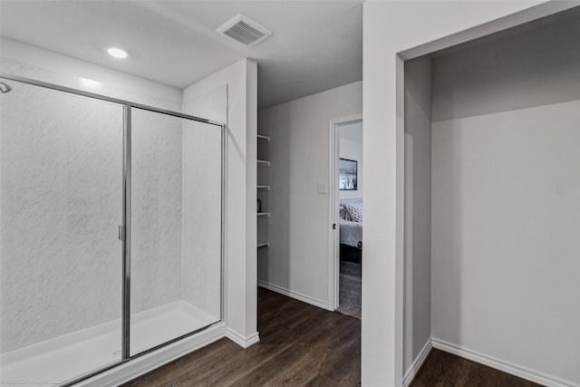 bathroom with walk in shower and wood-type flooring