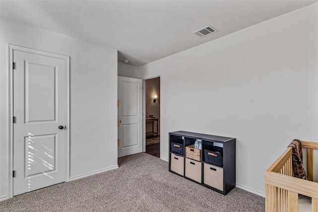 bedroom featuring a textured ceiling and carpet