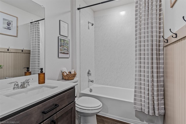 full bathroom featuring vanity, hardwood / wood-style floors, shower / bathtub combination with curtain, and toilet