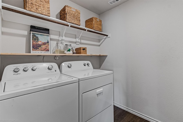 washroom with dark hardwood / wood-style flooring and washer and clothes dryer