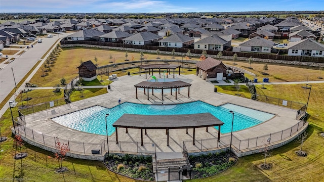 view of pool with a lawn