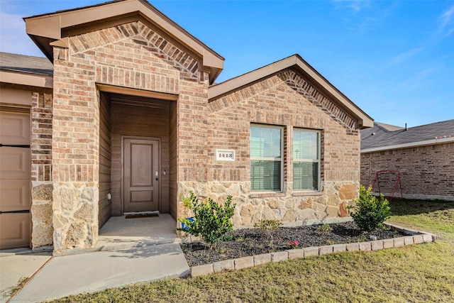 doorway to property featuring a yard