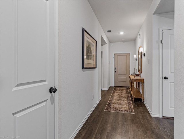 hallway with dark hardwood / wood-style floors