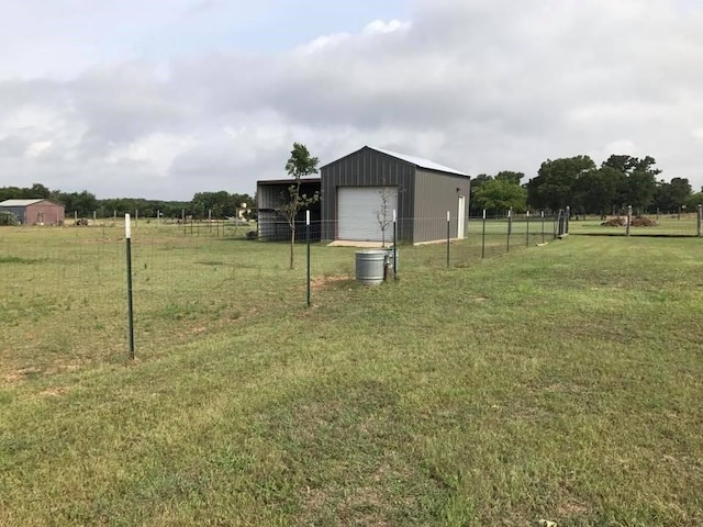 view of yard featuring a rural view and an outdoor structure