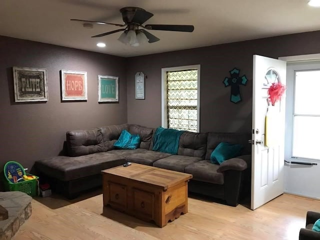 living room with plenty of natural light, ceiling fan, and light hardwood / wood-style flooring