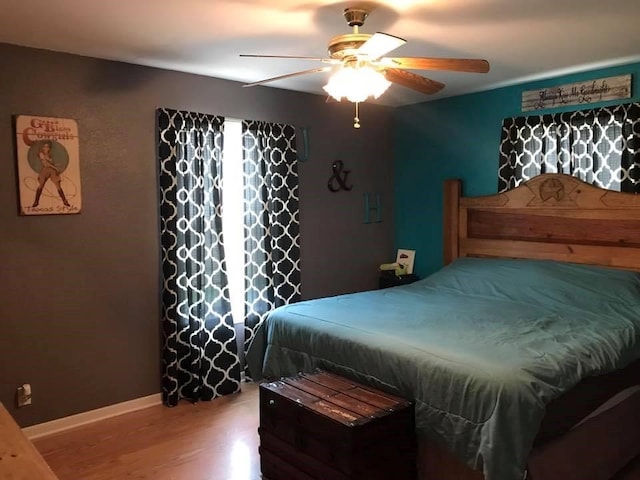 bedroom featuring hardwood / wood-style floors and ceiling fan