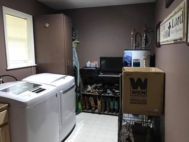 washroom with water heater and independent washer and dryer