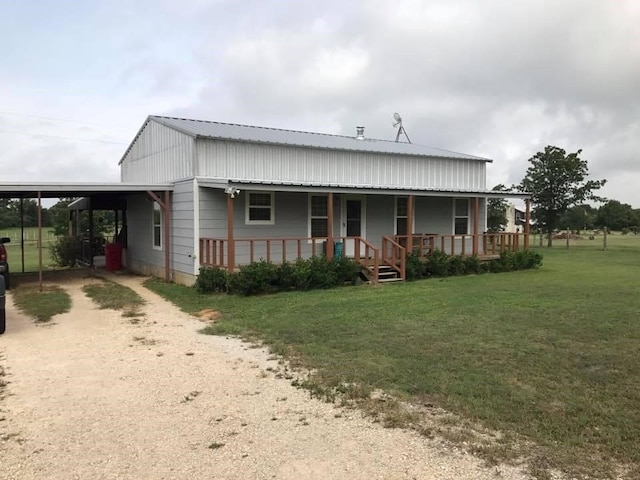 view of front of property featuring covered porch, a carport, and a front yard