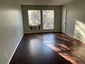 empty room featuring dark hardwood / wood-style flooring