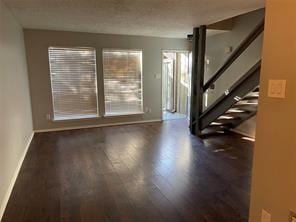 spare room featuring dark wood-type flooring