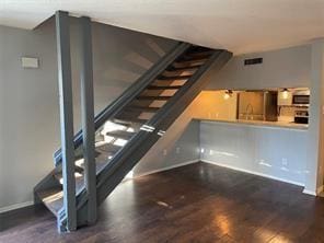 staircase with hardwood / wood-style floors