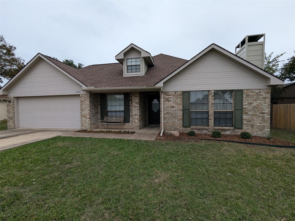 view of front of house featuring a garage and a front lawn