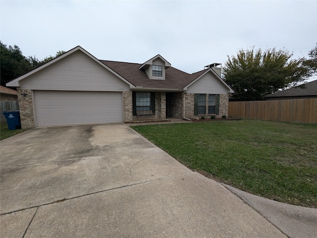 view of front of property featuring a garage and a front yard