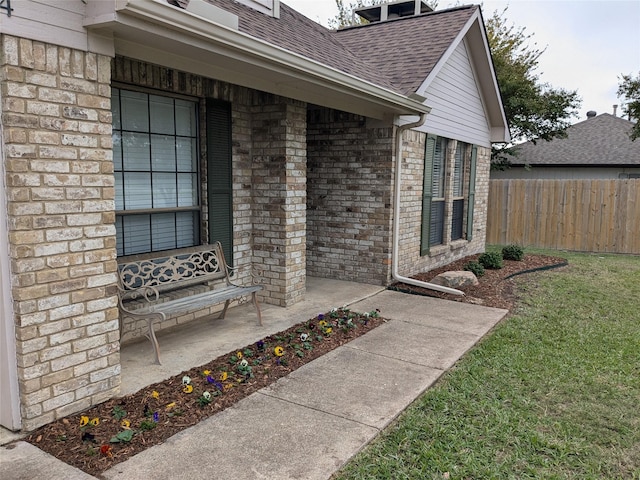 doorway to property with a lawn