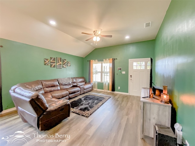 living room with ceiling fan, light hardwood / wood-style floors, and lofted ceiling