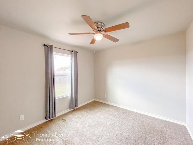 carpeted spare room with ceiling fan