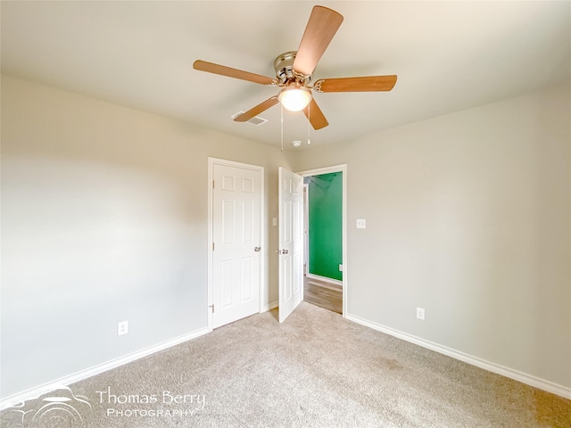 carpeted empty room with ceiling fan