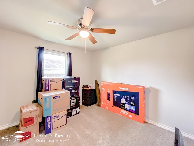 interior space with ceiling fan and light colored carpet