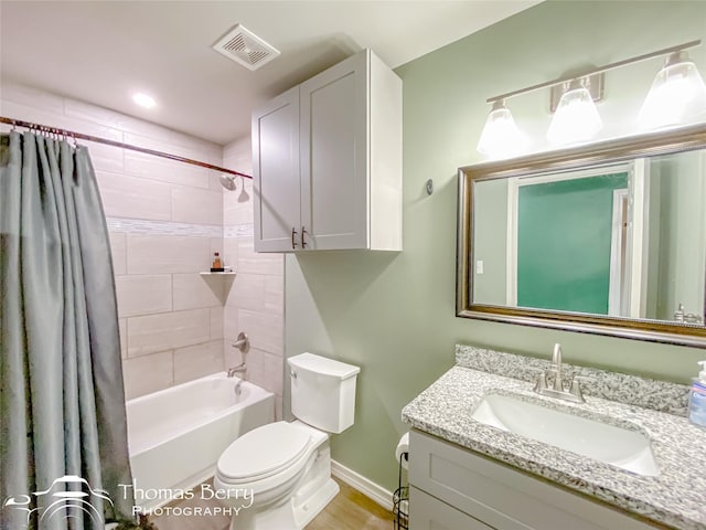 full bathroom featuring vanity, shower / tub combo, and toilet