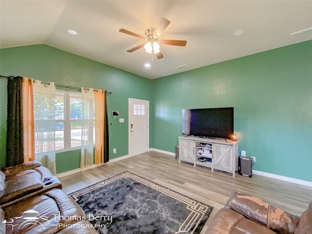 living room with ceiling fan, light wood-type flooring, and lofted ceiling