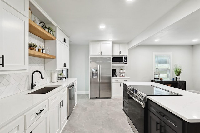 kitchen featuring white cabinets, decorative backsplash, sink, and stainless steel appliances