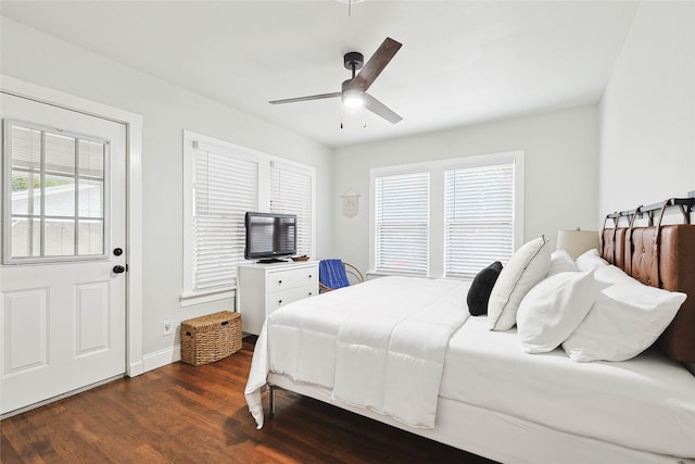 bedroom with dark hardwood / wood-style floors and ceiling fan