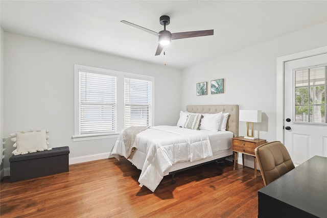 bedroom with dark hardwood / wood-style floors and ceiling fan