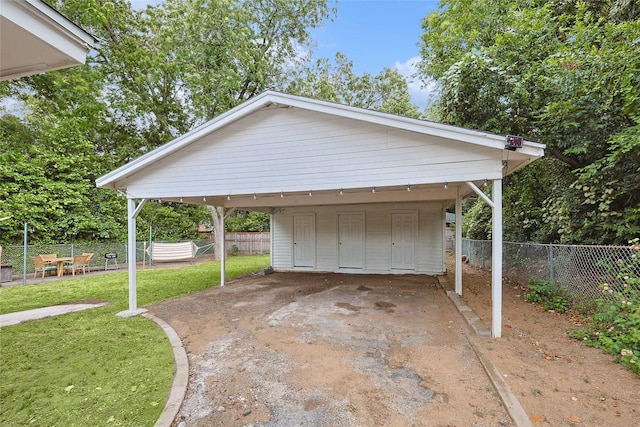 garage featuring a yard and a carport