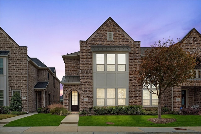 english style home with a yard