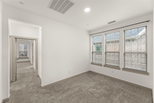 carpeted empty room with plenty of natural light