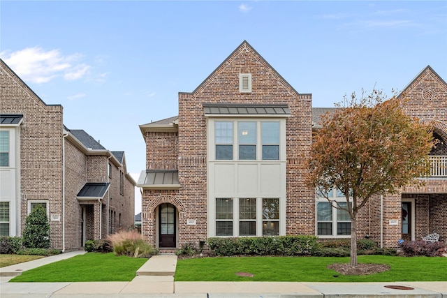 tudor-style house with a front yard