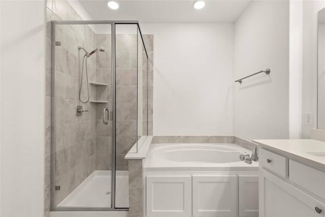 bathroom with vanity and independent shower and bath