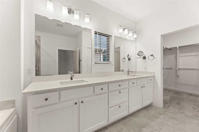 bathroom with vanity and a shower with shower door