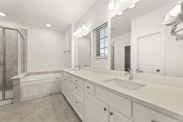 bathroom featuring tile patterned floors, vanity, and shower with separate bathtub