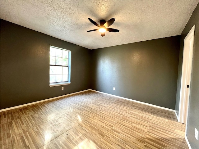 spare room featuring ceiling fan, a textured ceiling, and light wood-type flooring