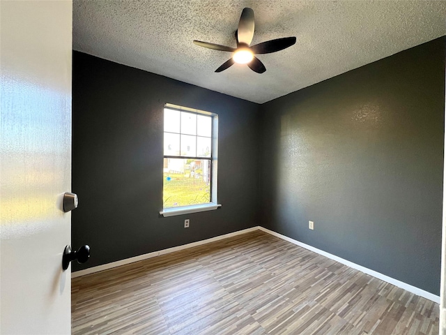 empty room featuring hardwood / wood-style floors, a textured ceiling, and ceiling fan