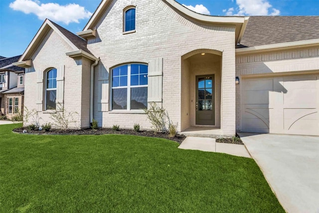 exterior space featuring a front lawn and a garage