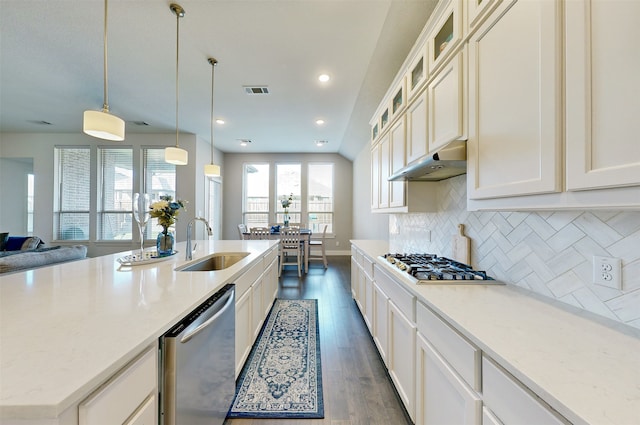 kitchen featuring sink, dark hardwood / wood-style floors, backsplash, decorative light fixtures, and appliances with stainless steel finishes