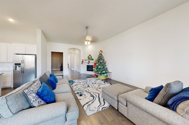 living room featuring light wood-type flooring and ceiling fan