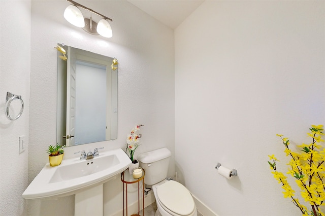 bathroom featuring sink and toilet